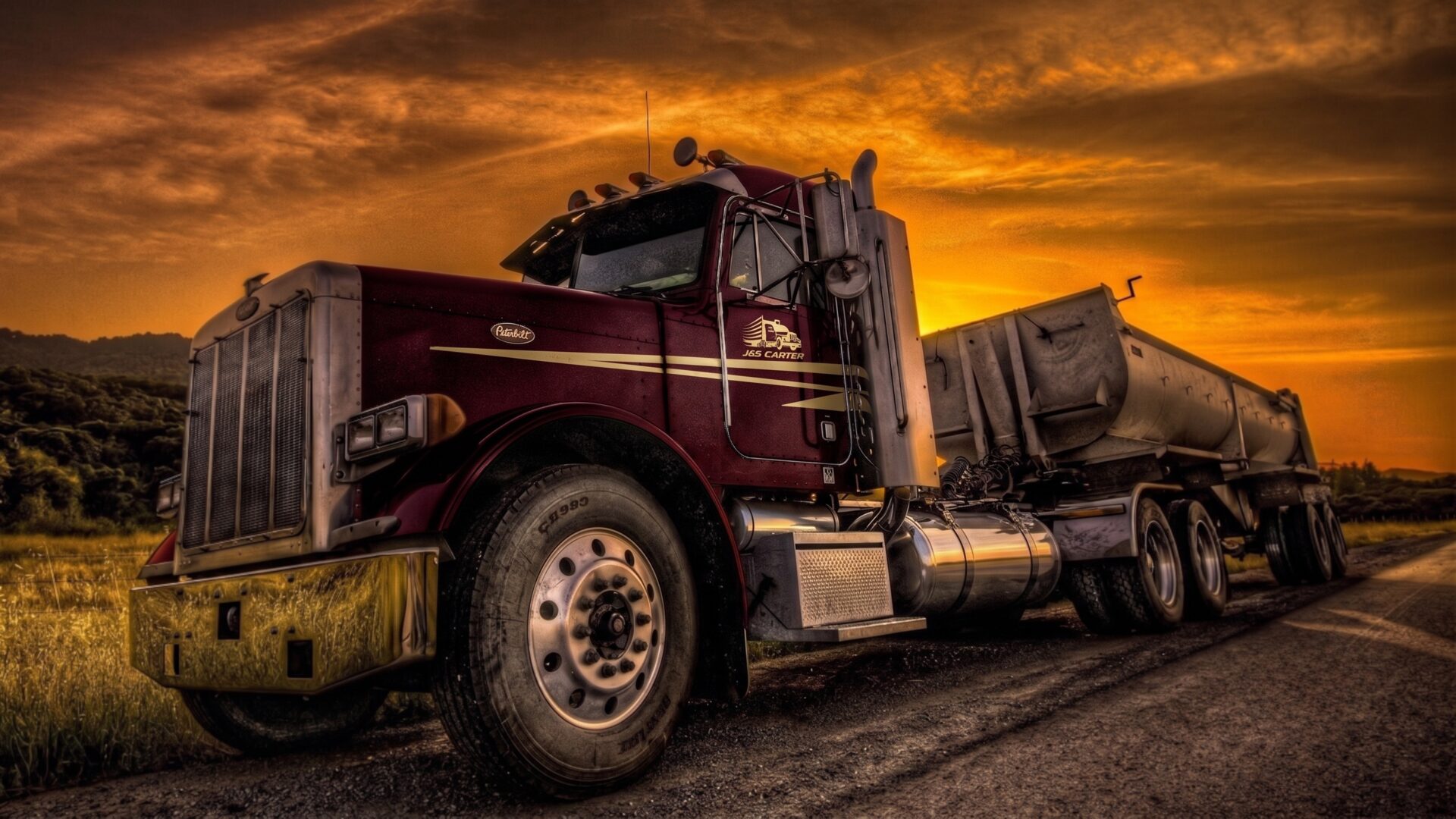 J&S Carter Peterbilt dump truck at sunset